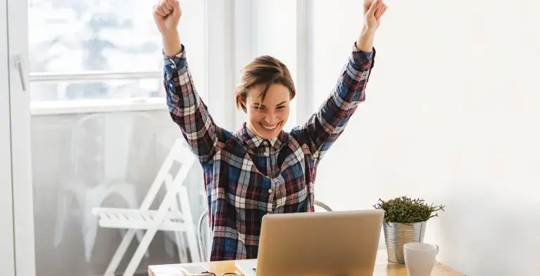 Vrouw juicht achter computer