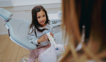 Een jong meisje krijgt voorlichting over mondverzorging